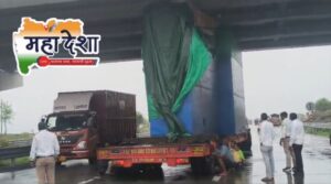 Tall container gets stuck under a bridge on the Samruddhi Mahamarg.