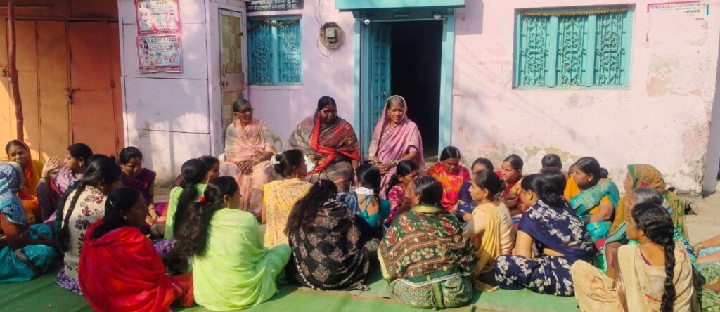 Women sitting in front of a liquor shop